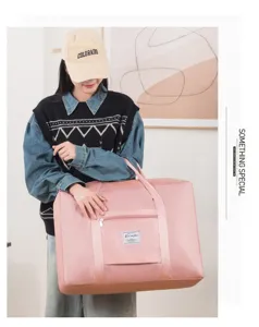 Sac de voyage pliable grande capacite rose sac a main de rangement pour voyage et demenagement.