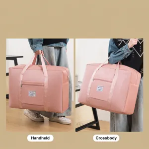Sac de voyage pliable de grande capacité sac de bagage rose avec sangle d'épaule réglable.
