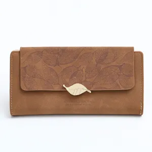 Brown matte long wallet detail featuring an engraved leaf pattern and gold leaf clasp.