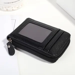 Minimalist black leather card holder with clear ID window and multiple accordion slots.