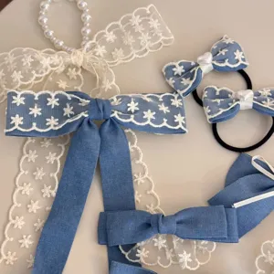 Sweet denim blue bow hair clips and ties with white lace trim and pearl charms for girls.