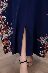 Close-up detailed view of the dark blue floral long dress featuring a chic front slit design.