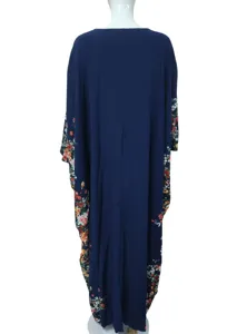 Floral print side detail of dark blue caftan maxi dress, loose comfortable fabric fit.