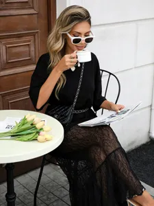 Black short sleeve dress with lace splice, elegant summer fashion style for women detail shot.