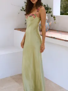 Elegant light green satin slip dress featuring delicate floral embroidery and slim straps.
