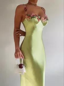 Green satin slip dress featuring floral embroidery, elegant V-neck and slim fit.