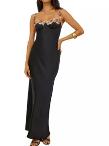 Black satin slip maxi dress with floral embroidered straps and elegant slim fit design.