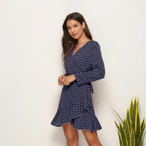 Detail view of the stylish navy blue polka dot wrap dress featuring chic V-neck and ruffles.
