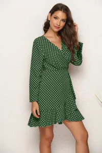 Green polka dot long sleeve wrap dress featuring an elegant V-neck and stylish ruffle hem.