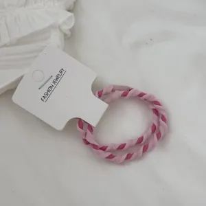 Detailed shot of two-pack pink braided hair ties with candy colors and high elasticity.