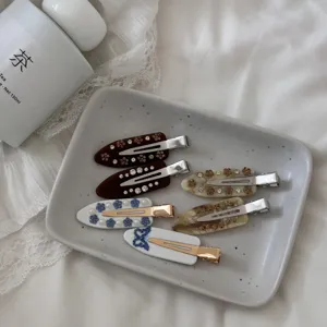 French acetate hair clips set with delicate rhinestones, elegant side barrettes for daily wear.