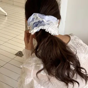 Light blue hair scrunchie with white lace trim, sweet style ponytail holder for women.