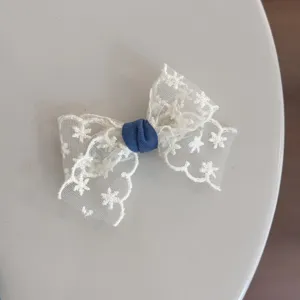 Sweet white lace bow hair clip with denim knot, perfect for cute daily girls hairstyles.