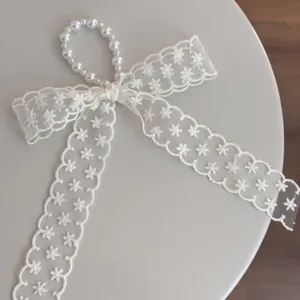 White lace bow hair clip with pearl loop sweet girl side clip elegant hair accessory detail