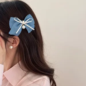 Sweet denim blue bow hair clip with pearl pendant for women, stylish side duckbill hairpin.