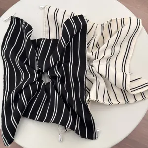 Chic black and white striped fabric hair scrunchie with delicate pearl pendants for women.