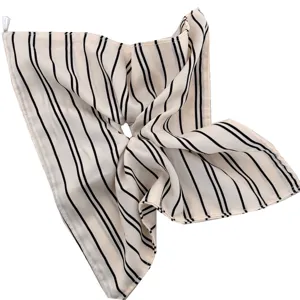 Minimalist black and white striped fabric hair scrunchie for elegant low ponytail styling.