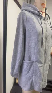 Detail shot of women's long grey zip-up hoodie, featuring a practical hood and front pockets.