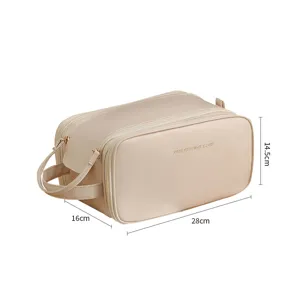 Large capacity travel makeup bag, portable beige toiletry organizer with dual zipper design.
