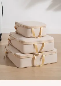 Detailed shot of beige travel packing cubes stacked neatly, ideal for luggage organization.