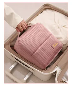 Quilted travel makeup bag for women, large capacity portable storage organizer for suitcase.