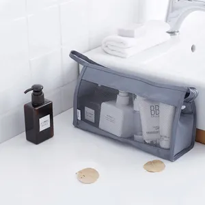 Grey triangular mesh toiletry bag, large capacity travel cosmetic storage organizer.