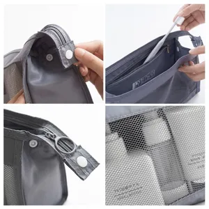 Grey mesh travel toiletry bag with large capacity, zipper and snap button for cosmetics.
