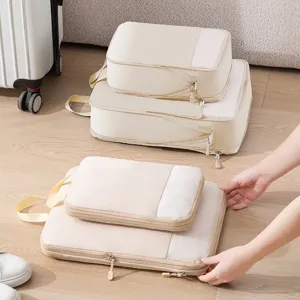Beige travel packing cubes set for clothes sorting, portable luggage organizers for trip.