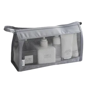 Grey travel cosmetic bag with mesh design, large capacity portable wash storage bag for daily use.