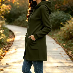 Outdoor detail view of a dark green fleece hooded jacket featuring pockets and zipper.