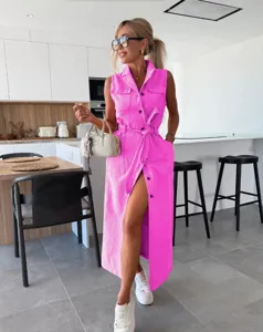 Pink sleeveless denim midi dress detail, belted waist and button-up design in modern setting.