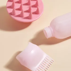 Set de cepillo de silicona para masajear el cuero cabelludo y botella aplicadora para el pelo.