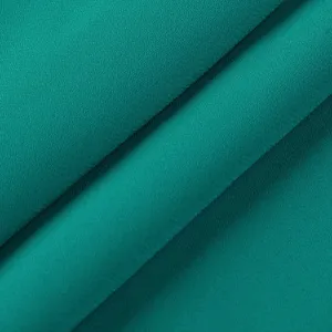 Close-up detail of smooth teal fabric with delicate texture and elegant draping folds.