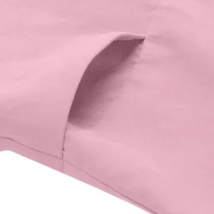 Close-up detail of the pocket on casual solid color pink trousers, showing fine fabric texture.