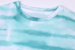Close-up detail of teal tie-dye gradient round neck long sleeve t-shirt fabric and collar.