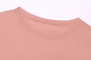 Detailed view of women's solid color crewneck long sleeve t-shirt collar and stitching.