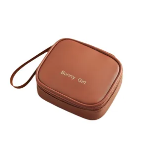 Astuccio cosmetico in pelle PU marrone e borsa di stoccaggio per assorbenti igienici.