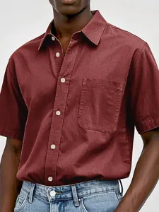 Men's casual short-sleeve button-up shirt in burgundy with chest pocket and white buttons.