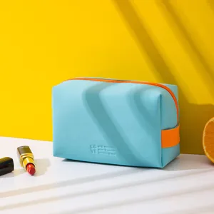 Light blue PU cosmetic bag, mini portable makeup storage pouch with orange zipper and handle.