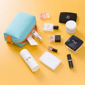 Portable PU cosmetic bag candy color travel makeup organizer with contrast orange zipper.