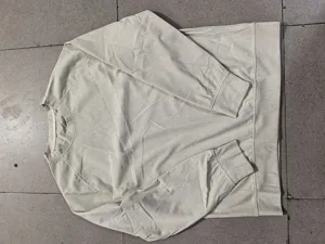 Close-up detailed view of casual men's corduroy long-sleeve sweatshirt flat lay style.