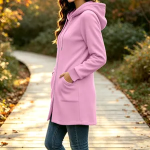 Casual pink fleece zip hoodie detail showcasing soft texture, long sleeves and side pockets.