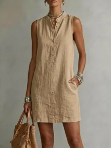 Detail view of women's casual linen sleeveless dress with button closure and pockets.
