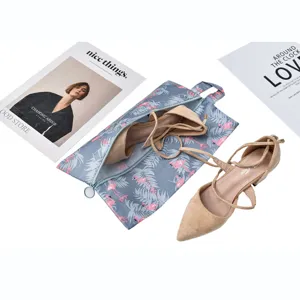 Travel foldable portable shoe storage bag organizer with flamingo print and high heels.