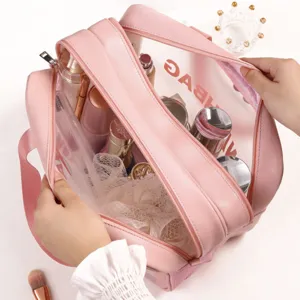 Pink double layer PU cosmetic bag with transparent compartment for waterproof travel storage.