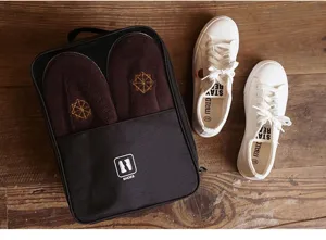 Portable travel shoe storage bag with mesh window, large capacity black footwear organizer.