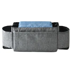 Stroller organizer bag with multiple storage pockets and blue denim accent for baby travel.