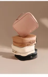 Detail view of multi-color PU leather cosmetic bags stacked neatly for travel organization.