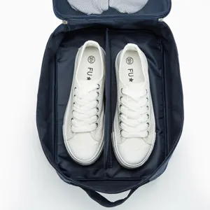 Portable travel shoe storage bag with large capacity, durable cationic fabric in dark blue.