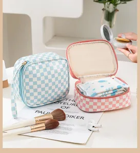 Detailed shot of portable checkerboard cosmetic and sanitary napkin storage bag with zipper.